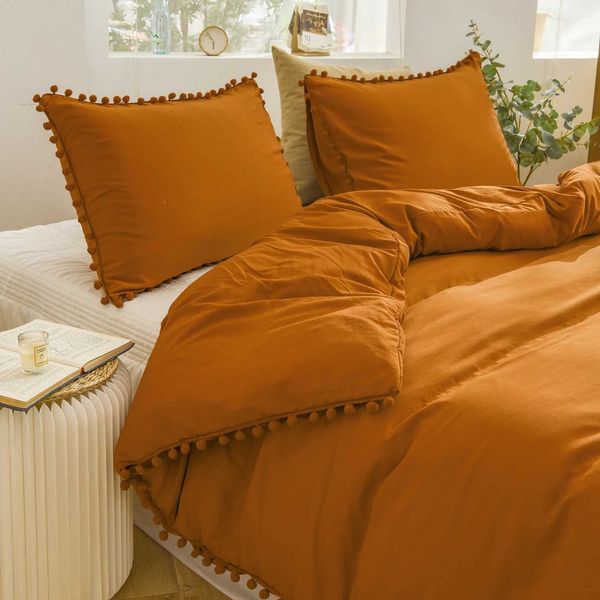 Burnt orange duvet cover set with pom poms in shabby chic style, soft solid-colored bedding without comforter