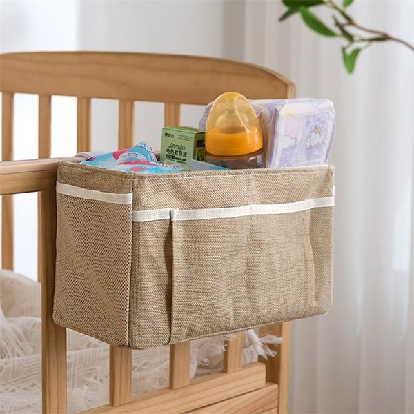 Canvas baby crib organizer with hanging storage for diapers, toys, and essentials