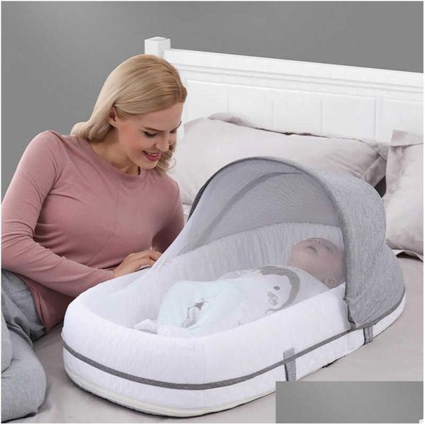 Portable baby crib featuring a mosquito net and travel bag, designed for newborns and infants up to 24 months with soft, breathable material